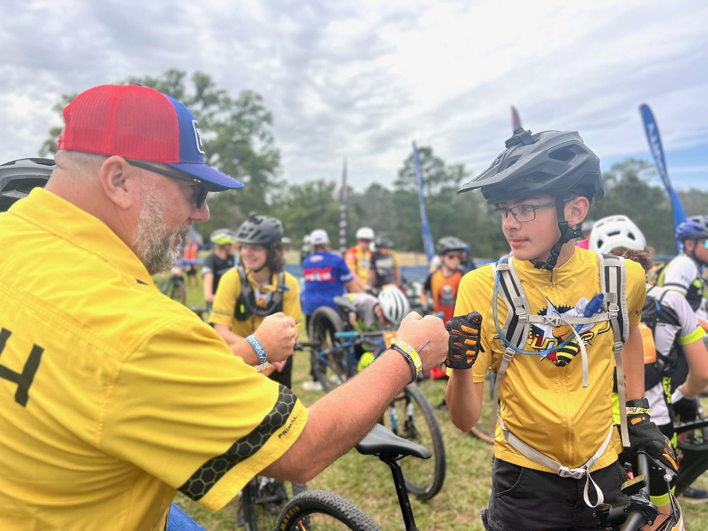 A Stingers coach giving a rider a fist bump before the start